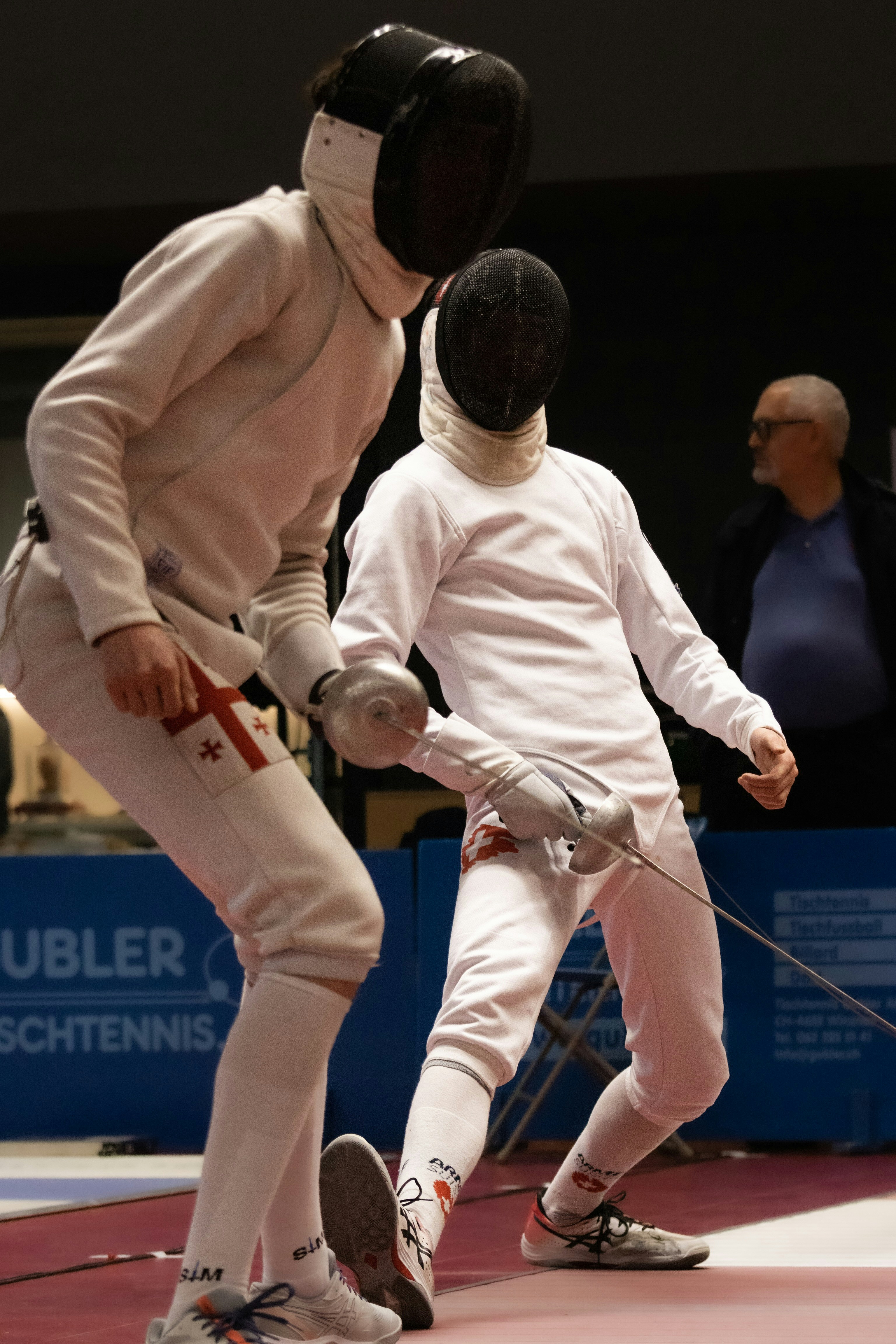 a couple of people that are standing on a wrestling ring