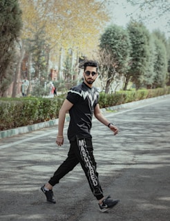 A person walking confidently in a park wearing stylish shoes.