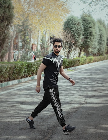 A person walking confidently in a park wearing stylish shoes.
