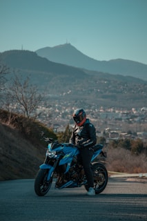 A rider gearing up on a sporty bike from Autoride, helmet in hand, with a scenic mountain backdrop