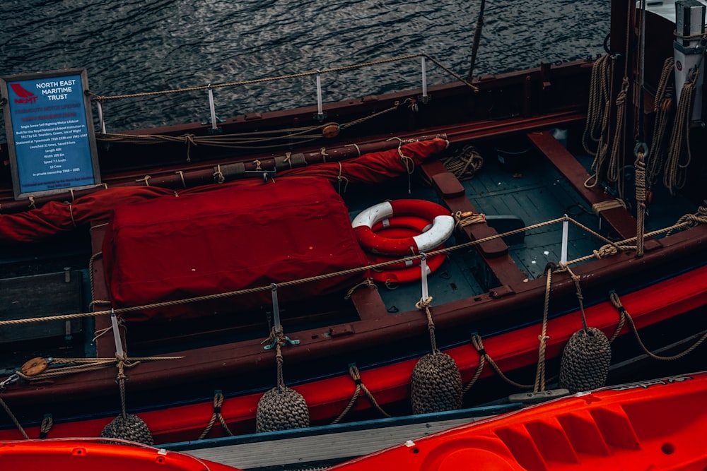 a red boat with a life preserver on top of it