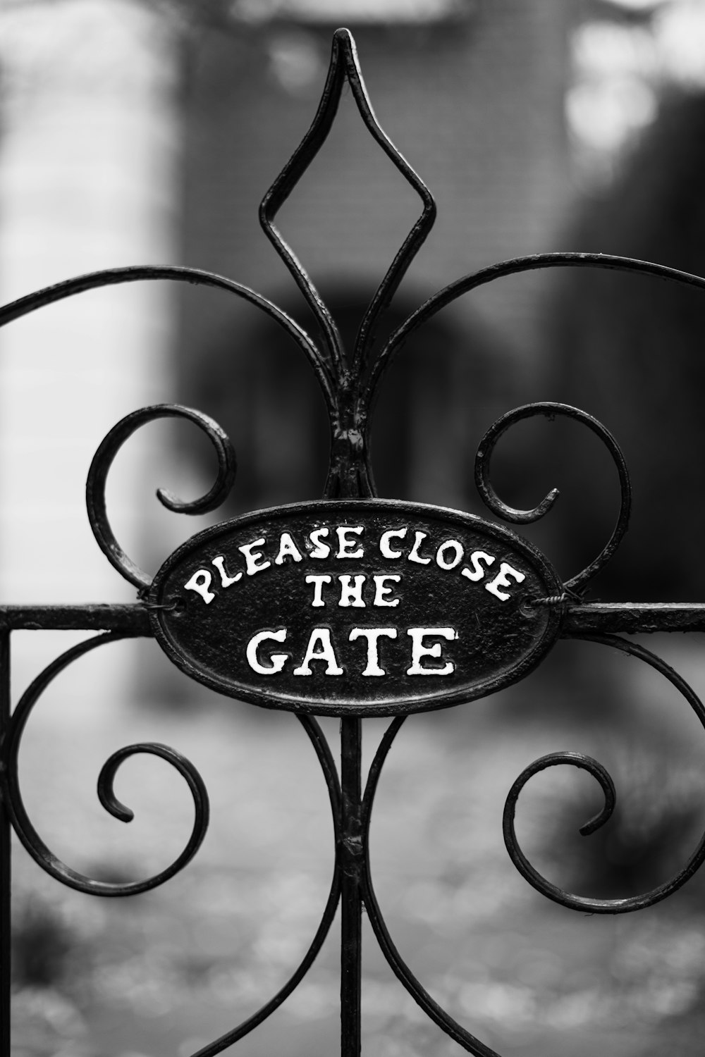 a gate with a sign that says please close the gate