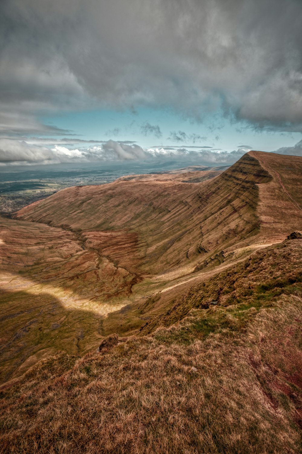 a view of a mountain with a cloudy sky