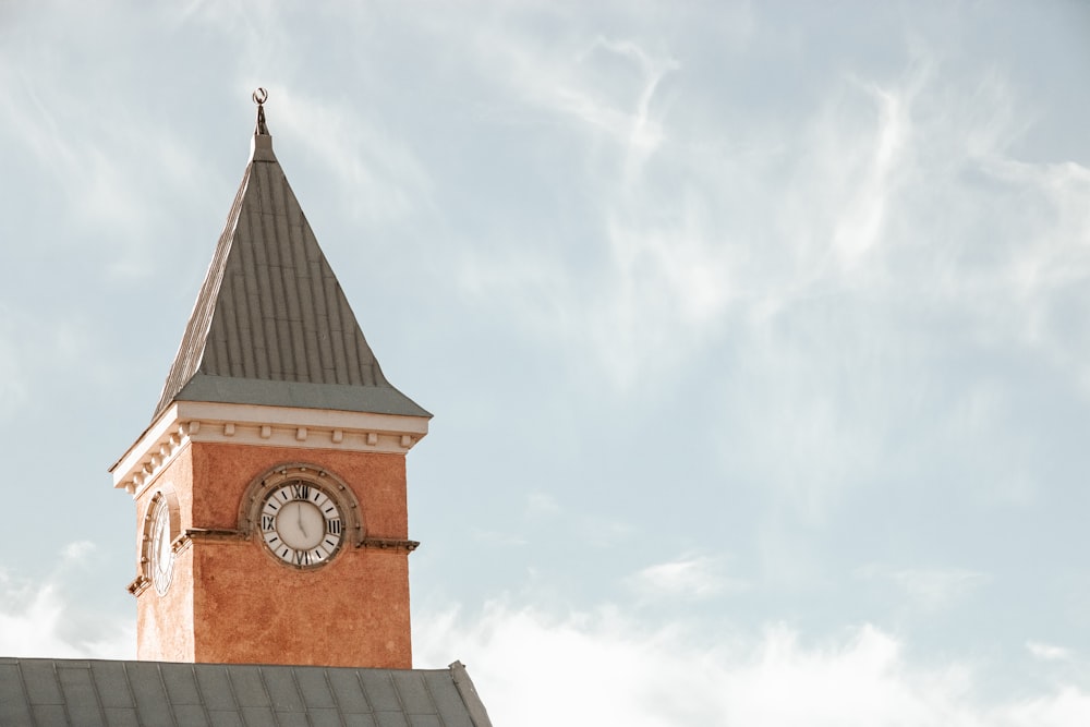 a clock tower on top of a building with a sky background