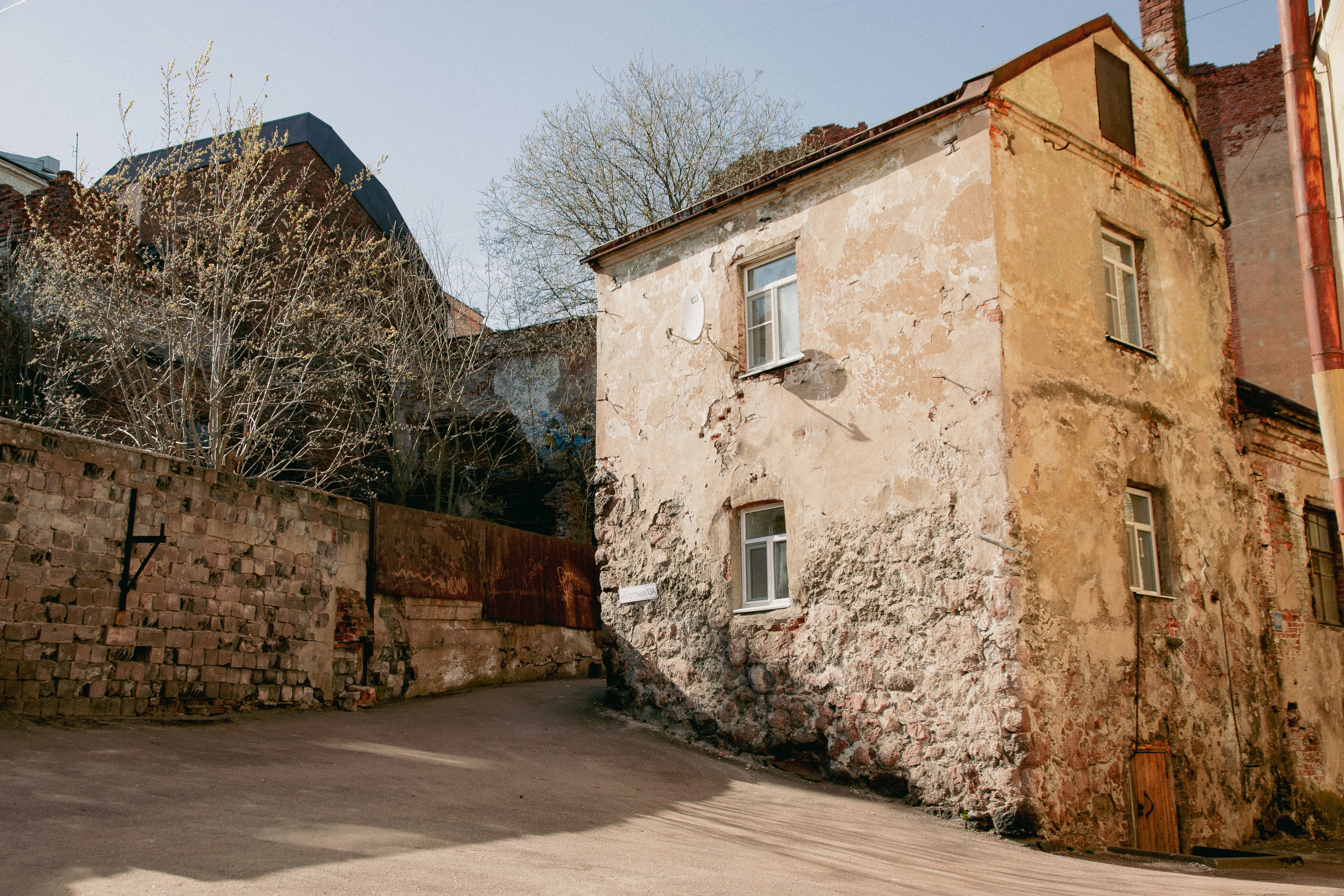 an old building with a stone wall next to it