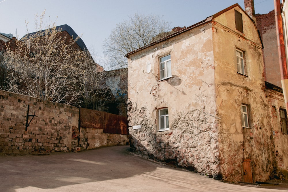 an old building with a stone wall next to it
