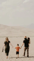 A family walking along a dirt road next to their newly purchased land in Moreno.