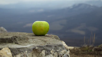 Close-up of a vibrant green apple resting on a rustic wooden table, symbolizing natural blood sugar balance.