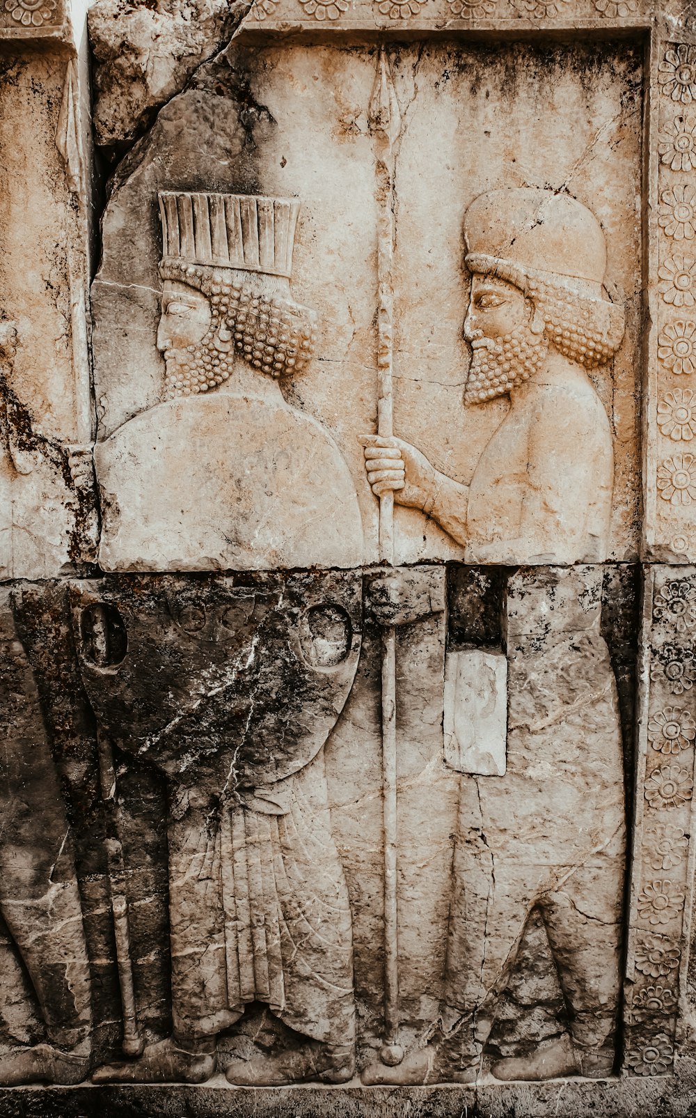 a close up of a carving of a man holding a broom