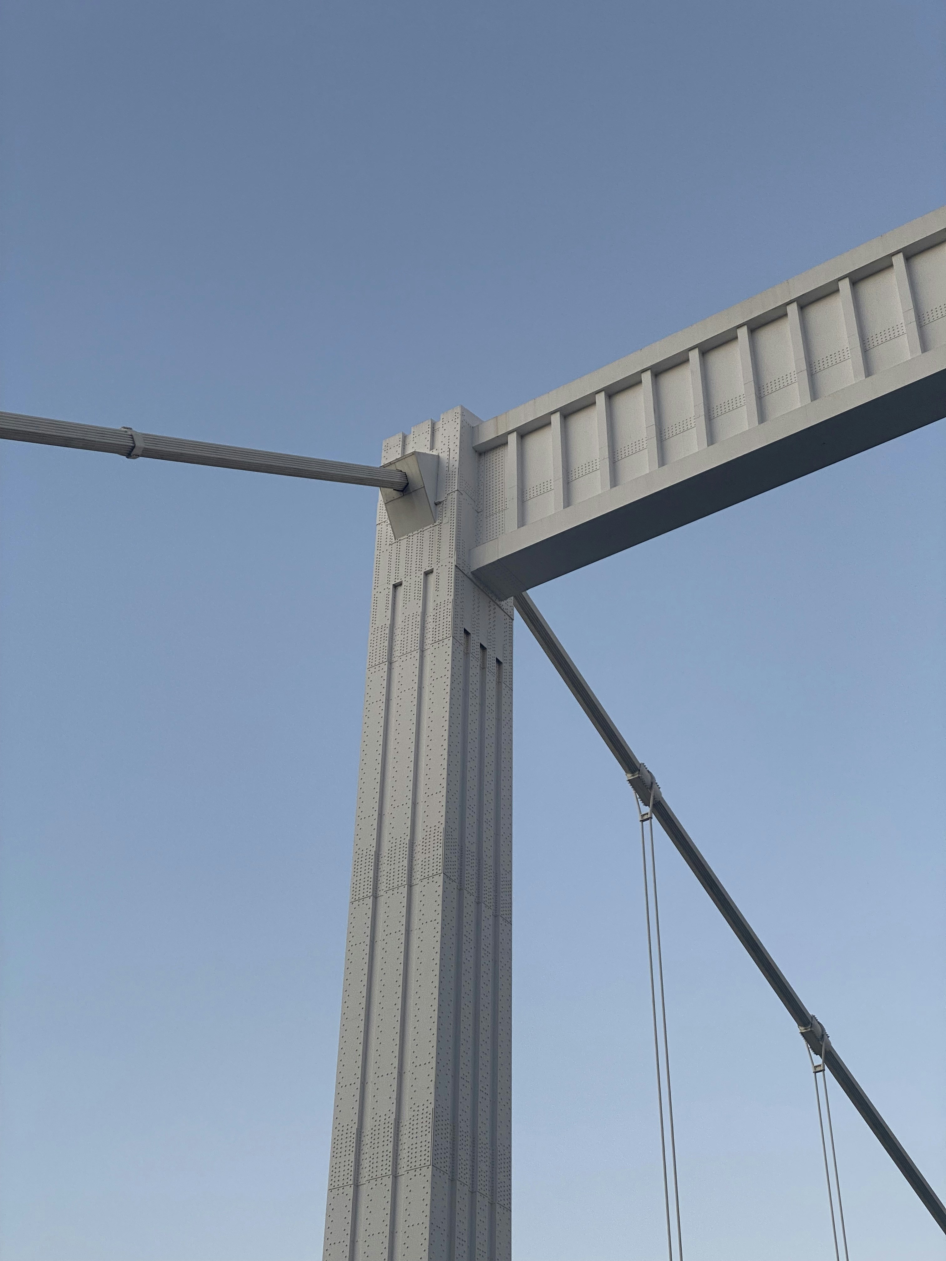 a traffic light on a bridge with a blue sky in the background
