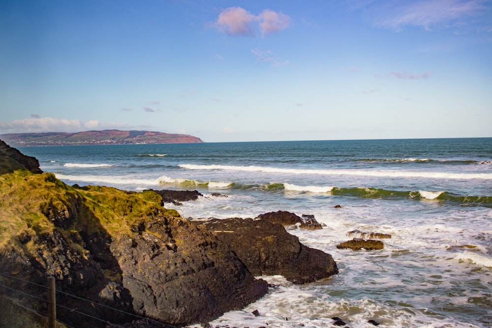 a view of the ocean from a rocky cliff