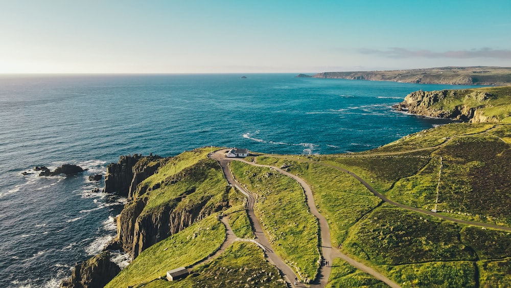 an aerial view of a road near the ocean