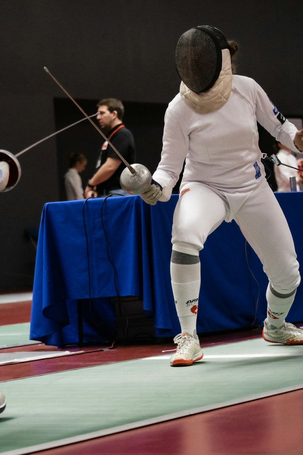 a person in a fencing stance with a sword
