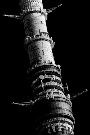 A towering obsidian monolith standing firm against a backdrop of deep shadows, symbolizing unyielding corporate defense.