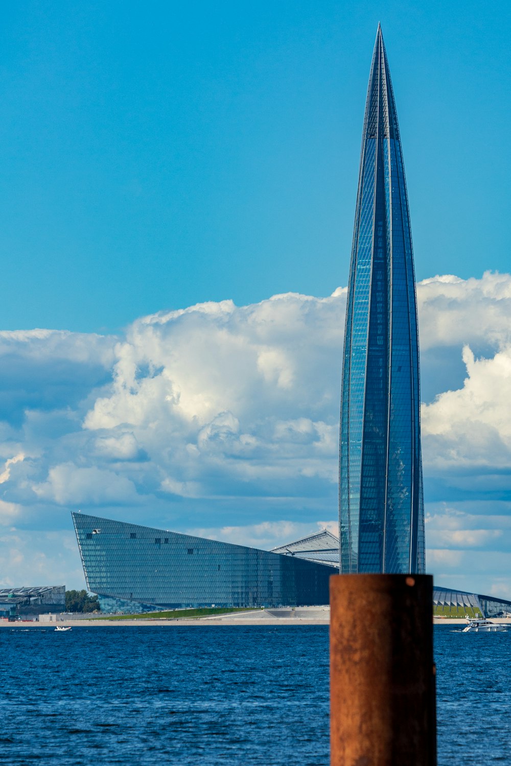 a very tall building sitting in the middle of a body of water