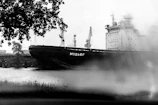 A cargo ship docked at Klaipeda port with crew members preparing for departure.