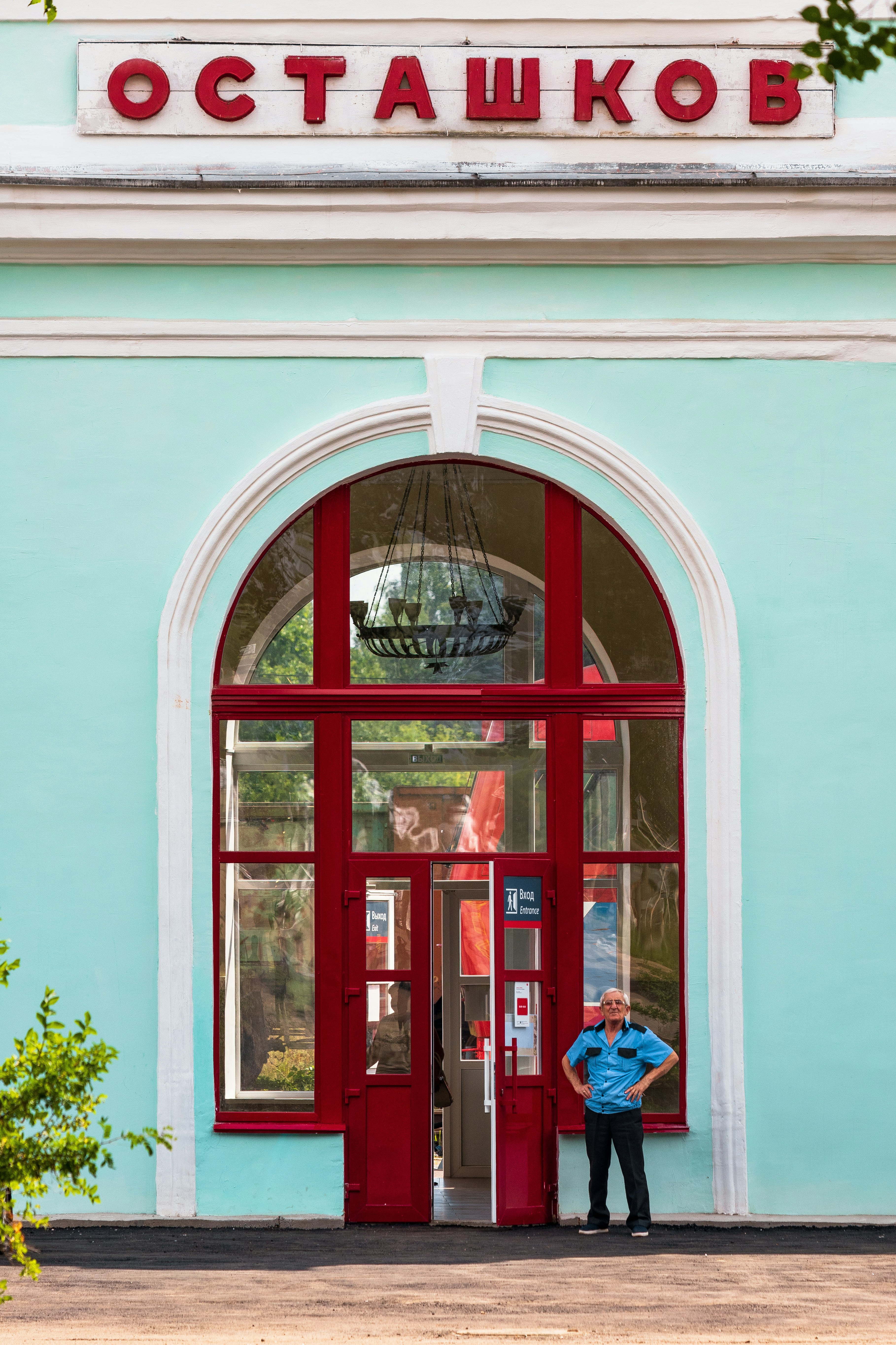 a man standing in front of a red door