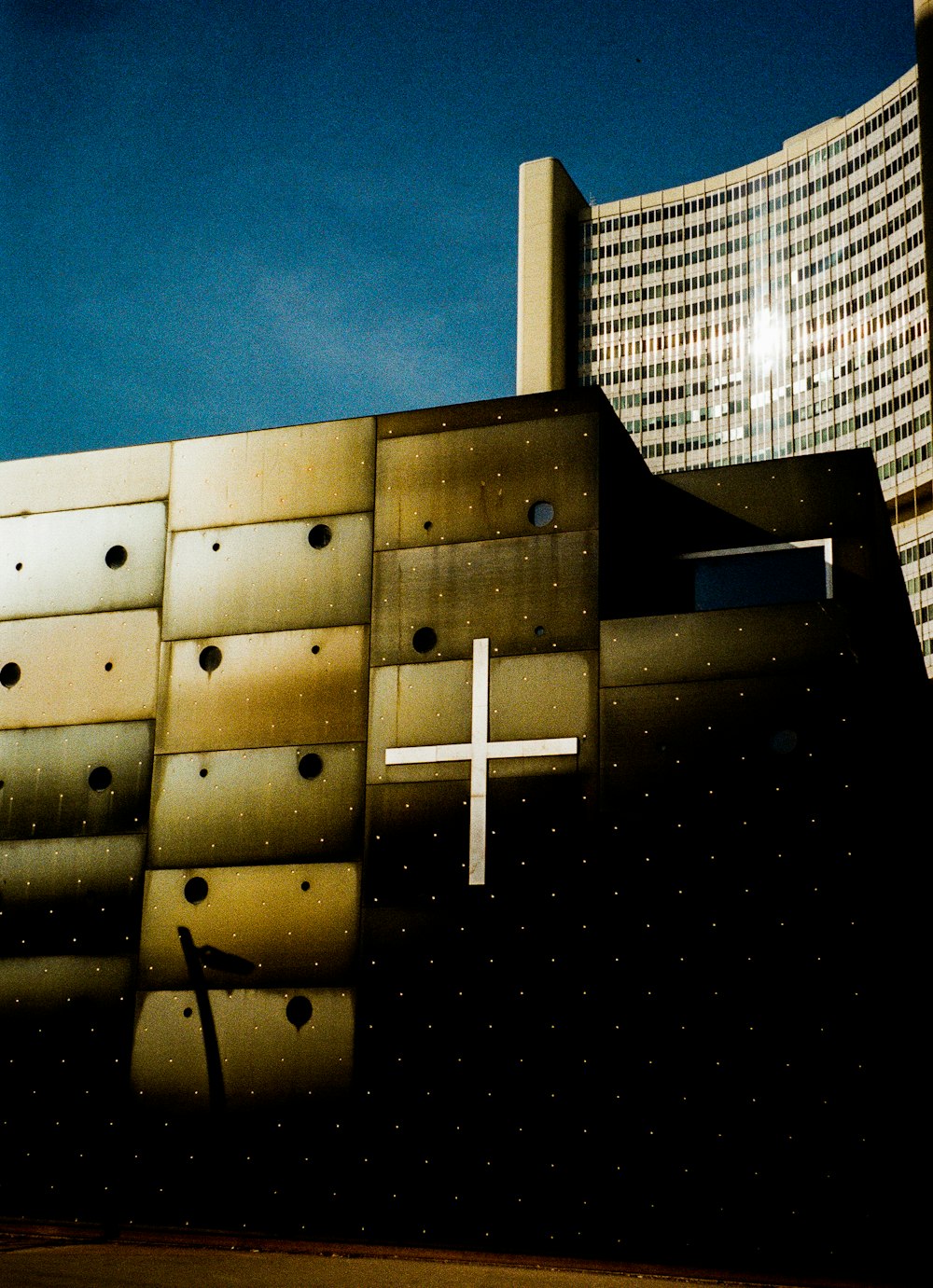 a building with a cross painted on the side of it