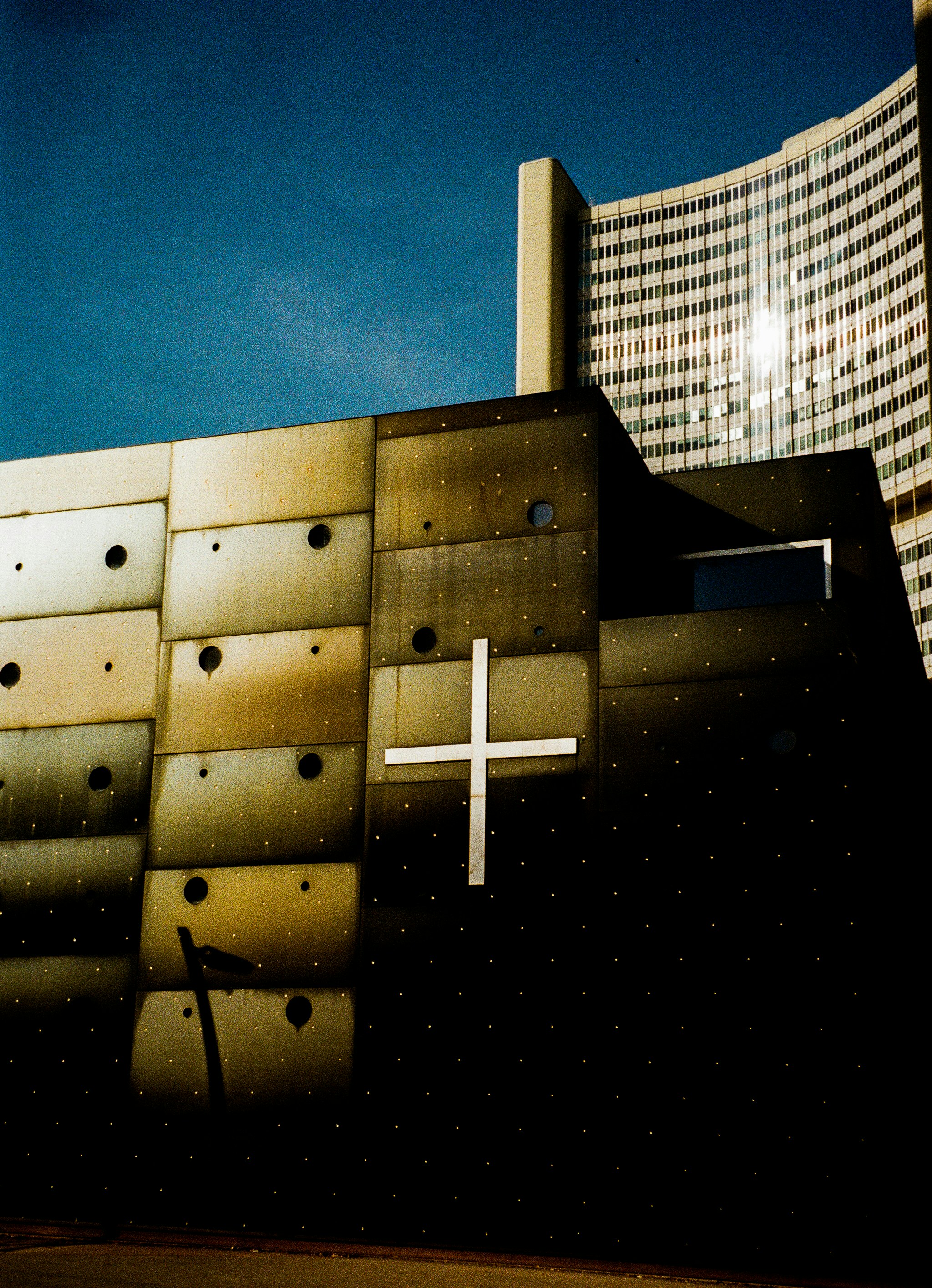 a building with a cross painted on the side of it