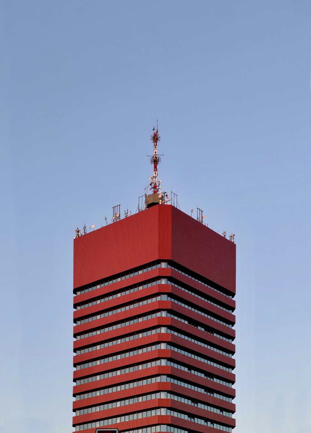 a tall red building with a sky background