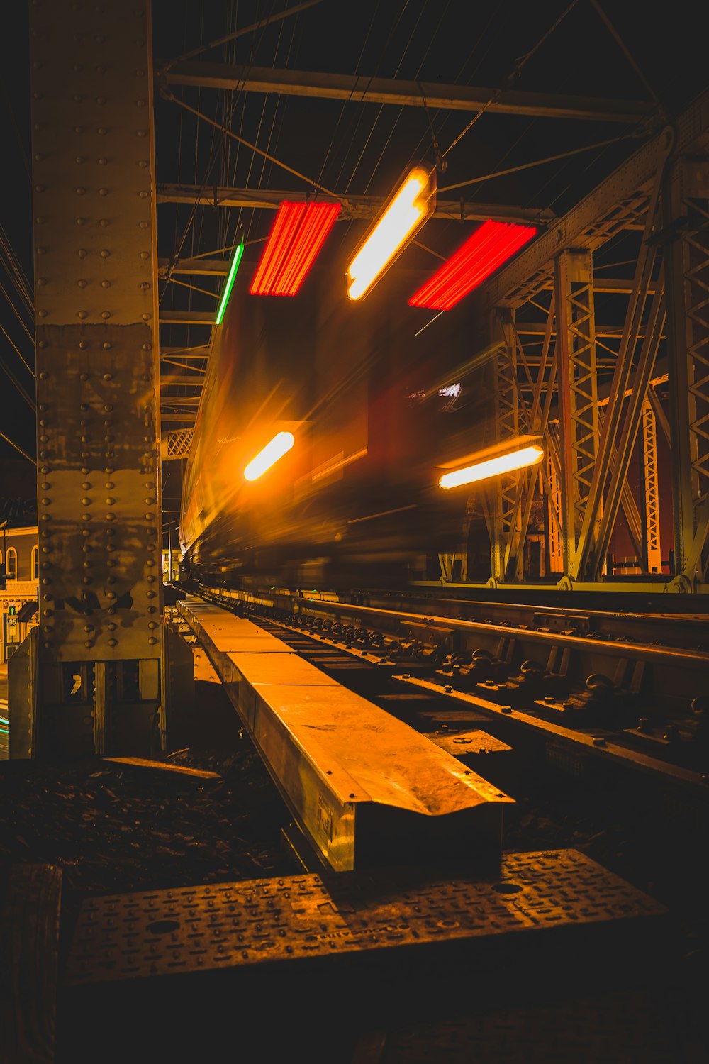 a train traveling down train tracks at night