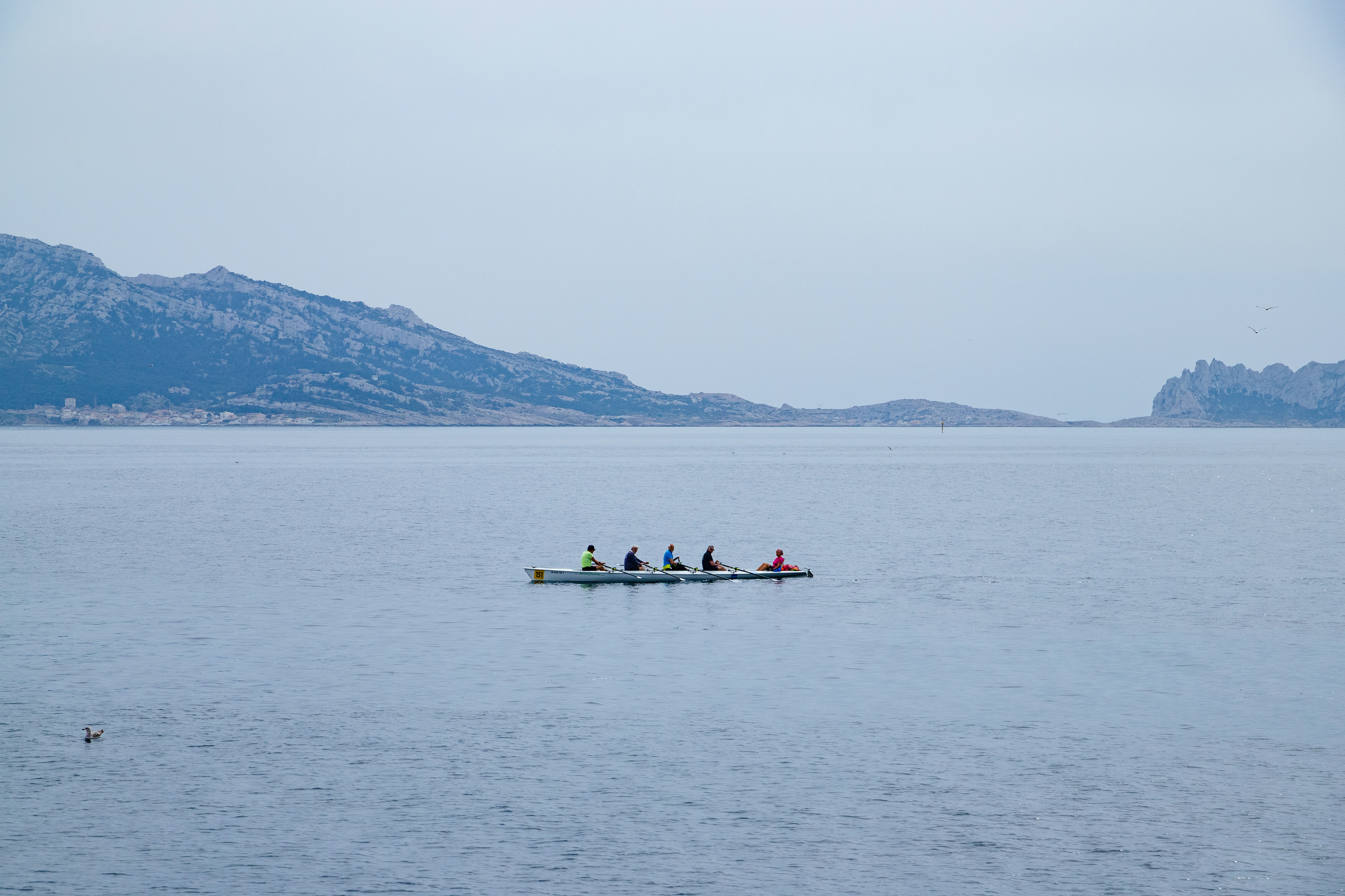 a group of people in a boat on a large body of water