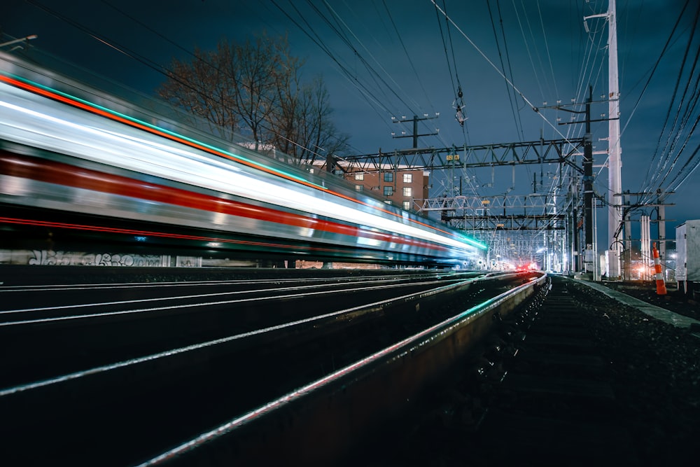 a train traveling down train tracks next to power lines