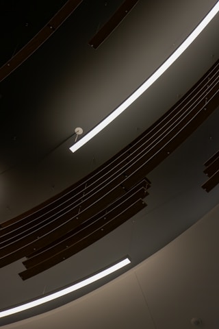 Minimalist architectural detail of a wooden ceiling with integrated lighting in a luxury home.