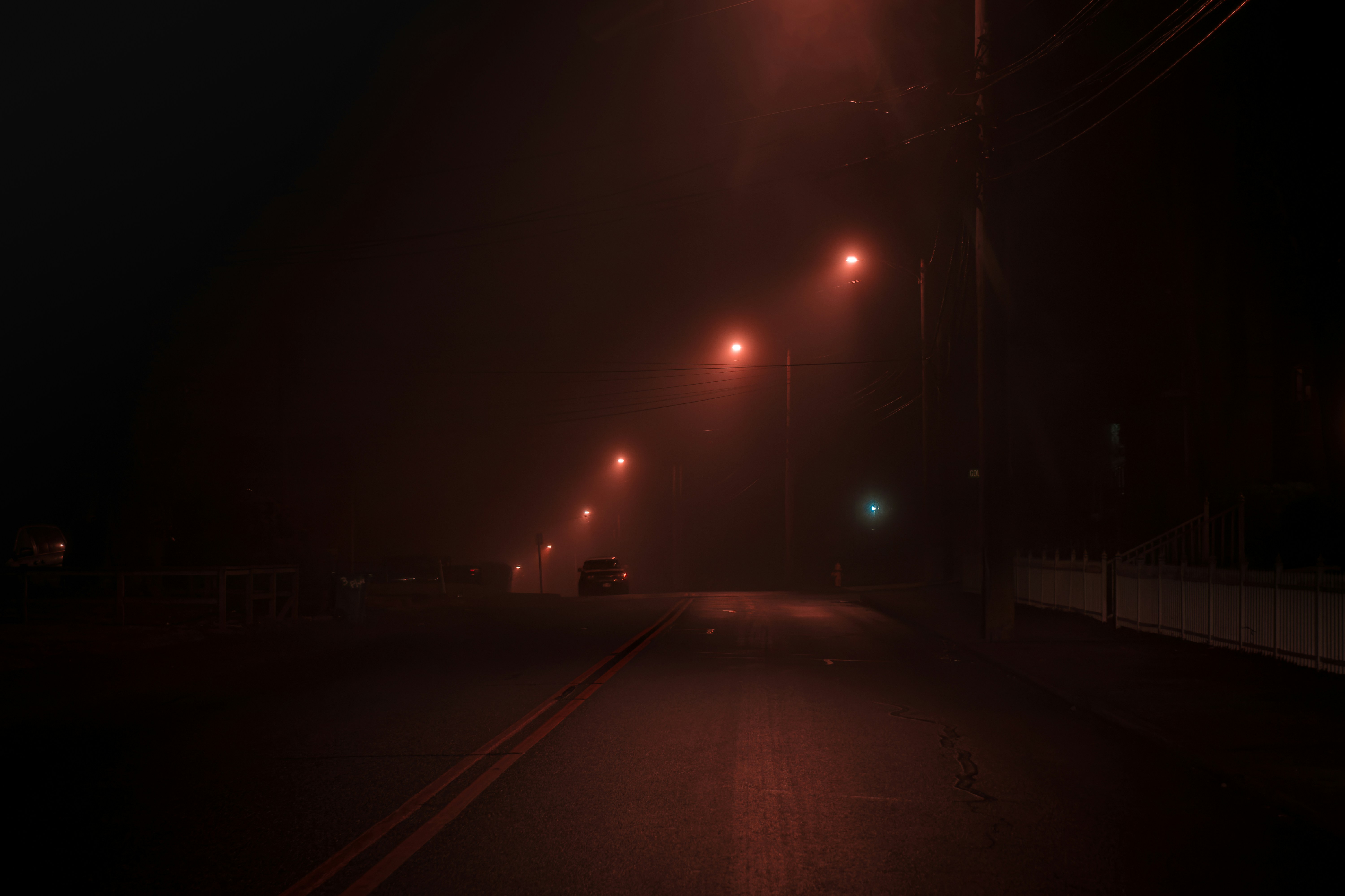 a dark street at night with street lights