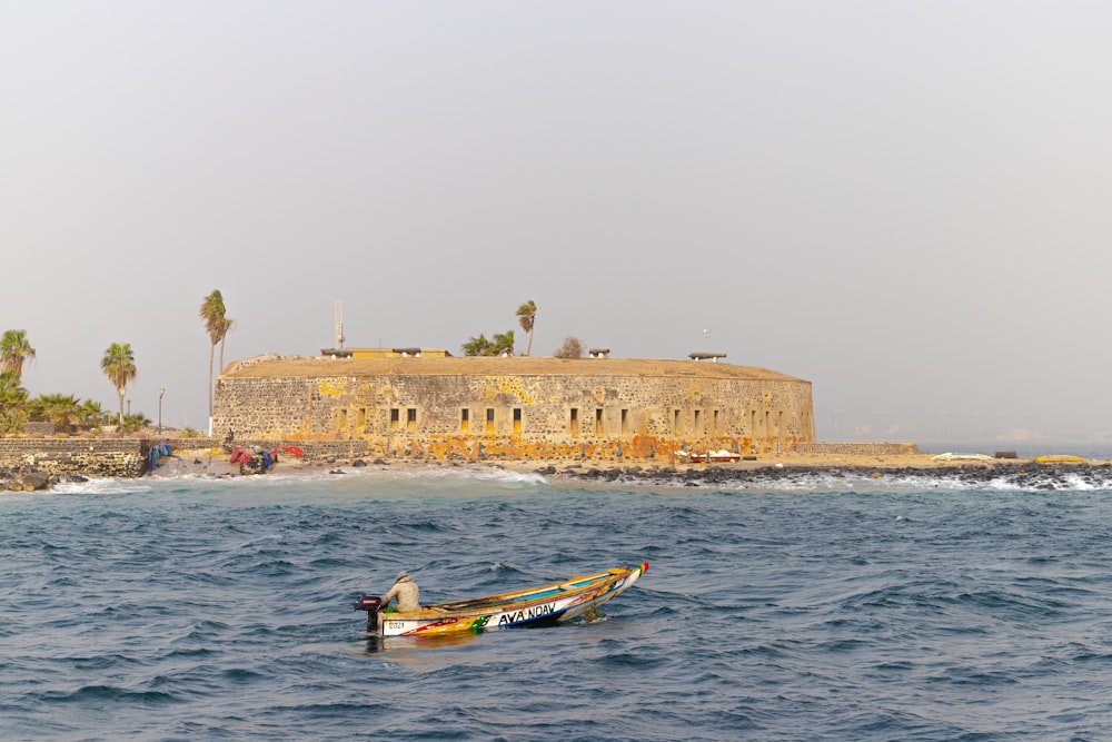 a small boat in the middle of a body of water