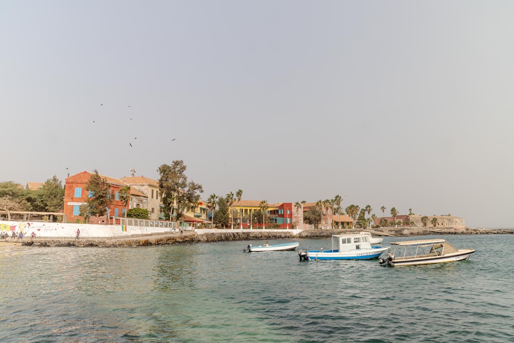 a group of boats floating on top of a body of water