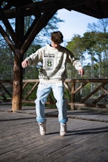 a young man riding a skateboard on a wooden deck