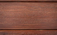 Close-up of natural wood textures on kitchen furniture paired with beige countertops.