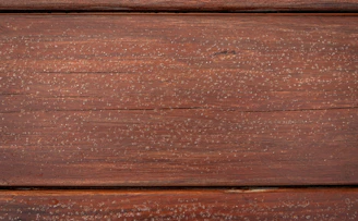 Close-up of natural wood textures on kitchen furniture paired with beige countertops.
