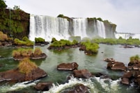 a large waterfall with a bunch of rocks in front of it
