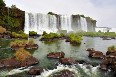a large waterfall with a bunch of rocks in front of it