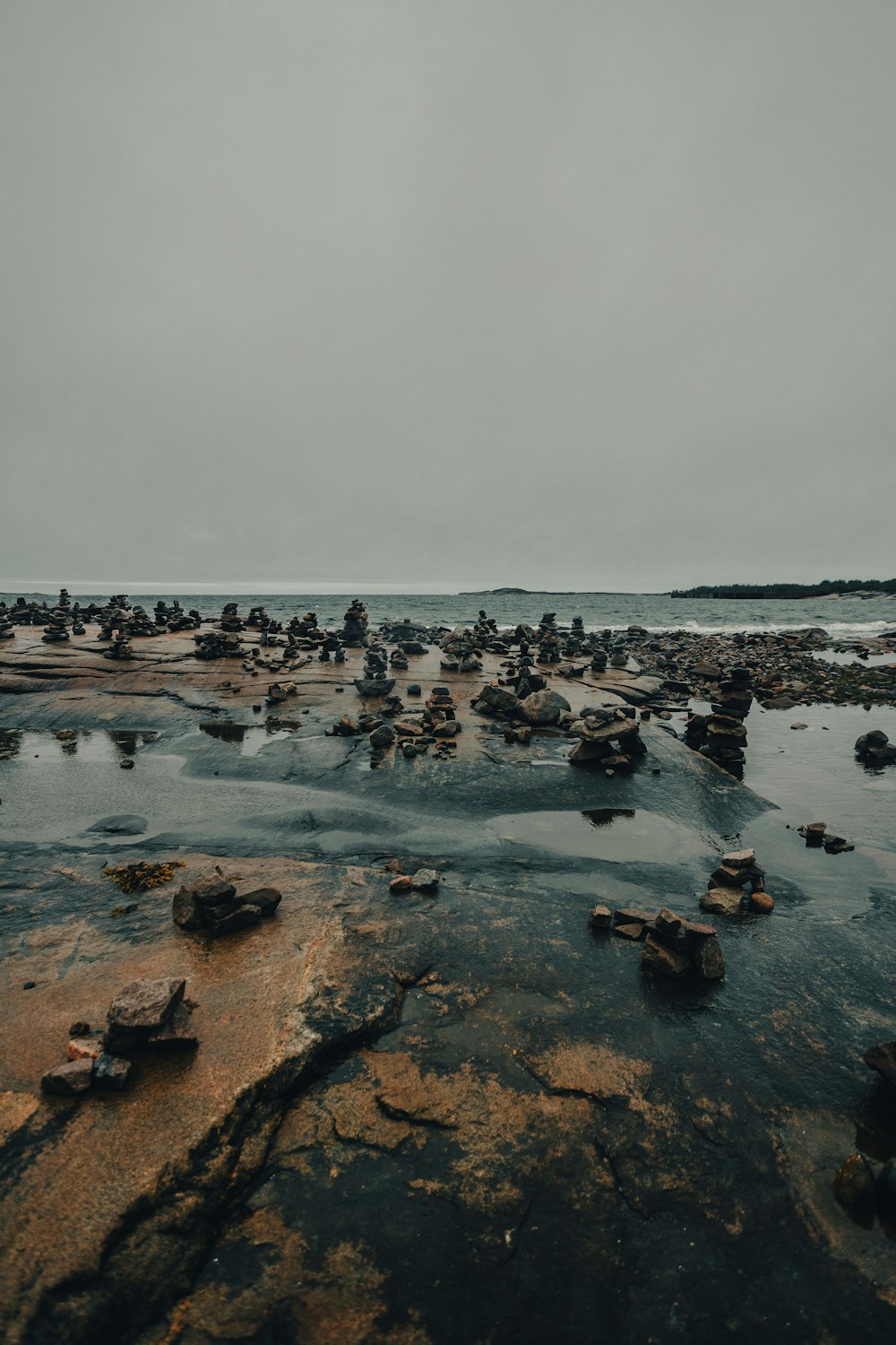 a group of rocks sitting on top of a beach