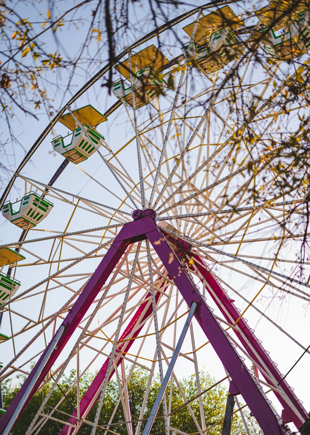 a large ferris wheel sitting next to a forest