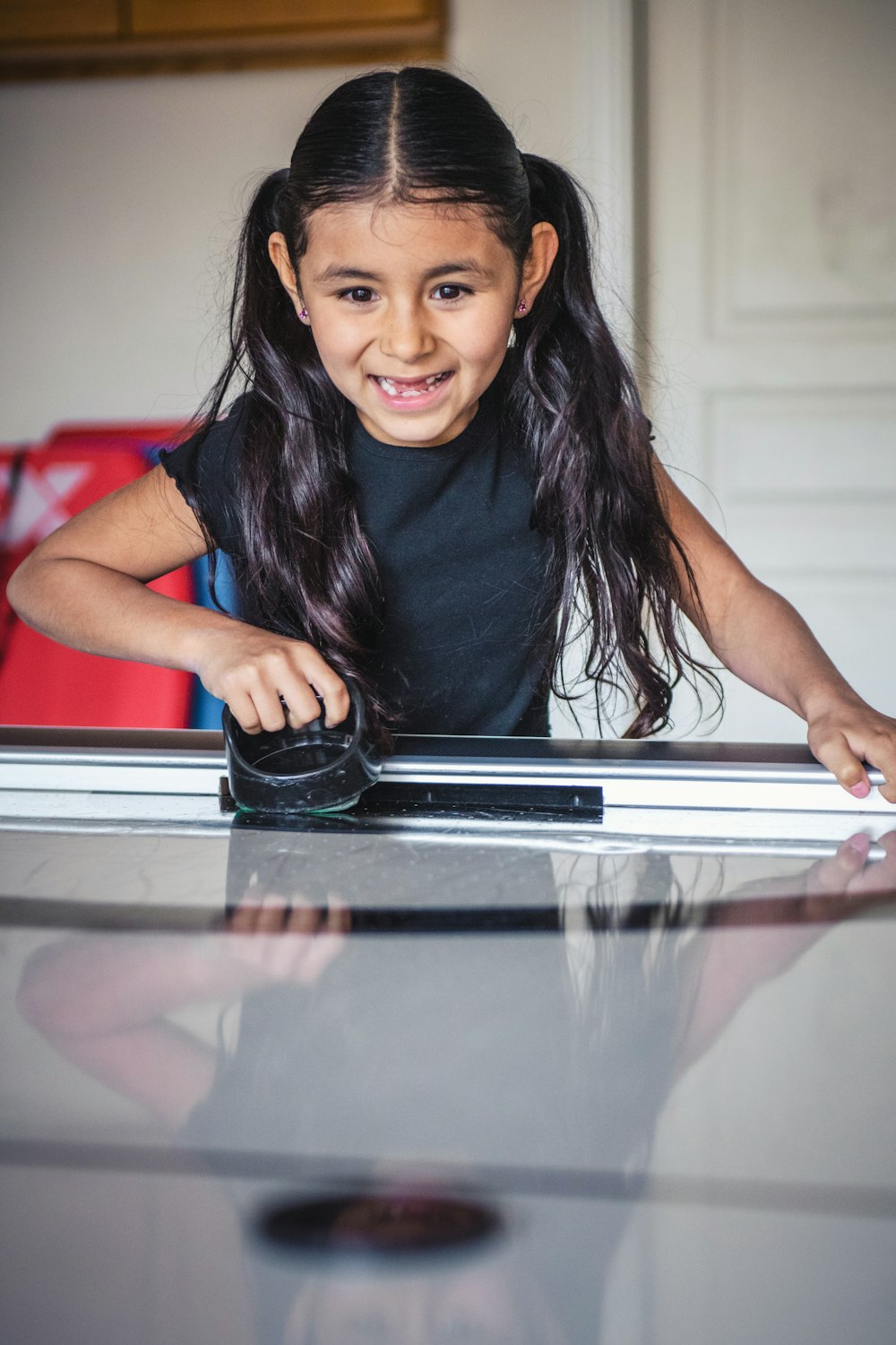 a little girl that is sitting at a table