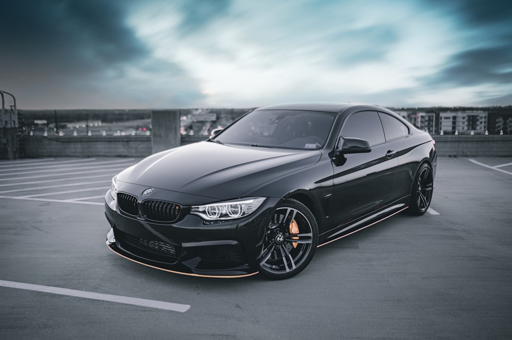 a black car parked in a parking lot