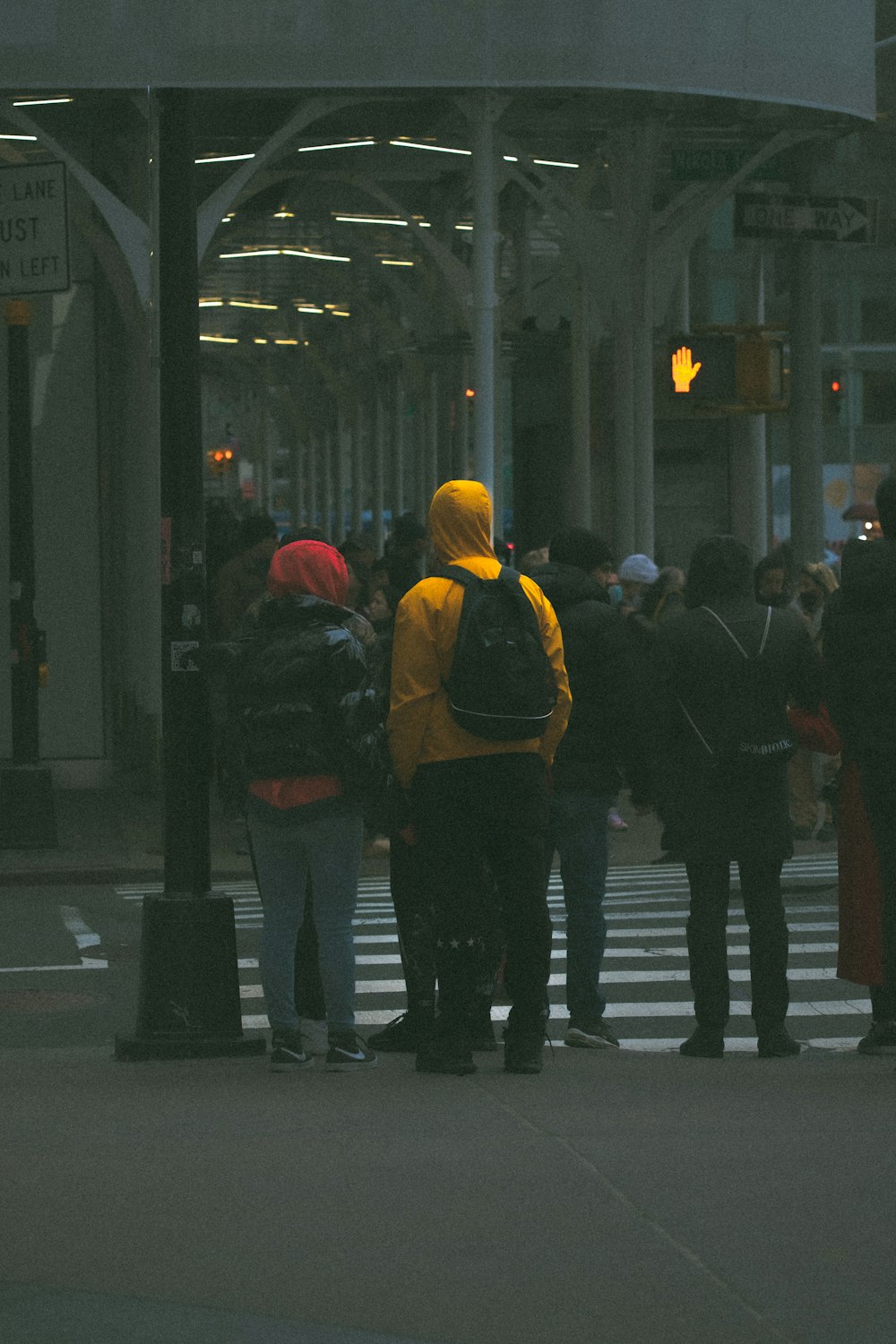 a group of people standing on a street corner