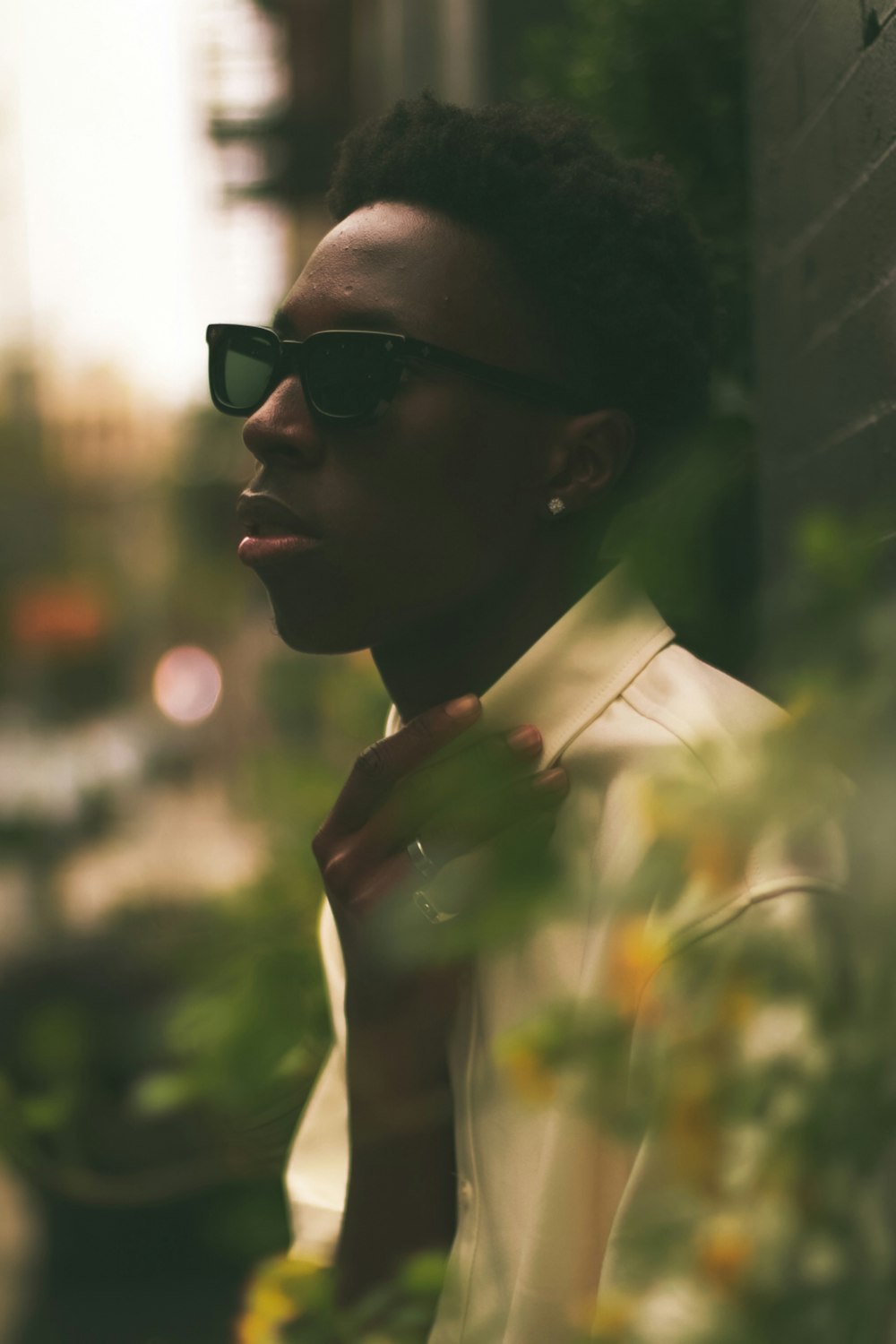 a man wearing sunglasses and a white shirt