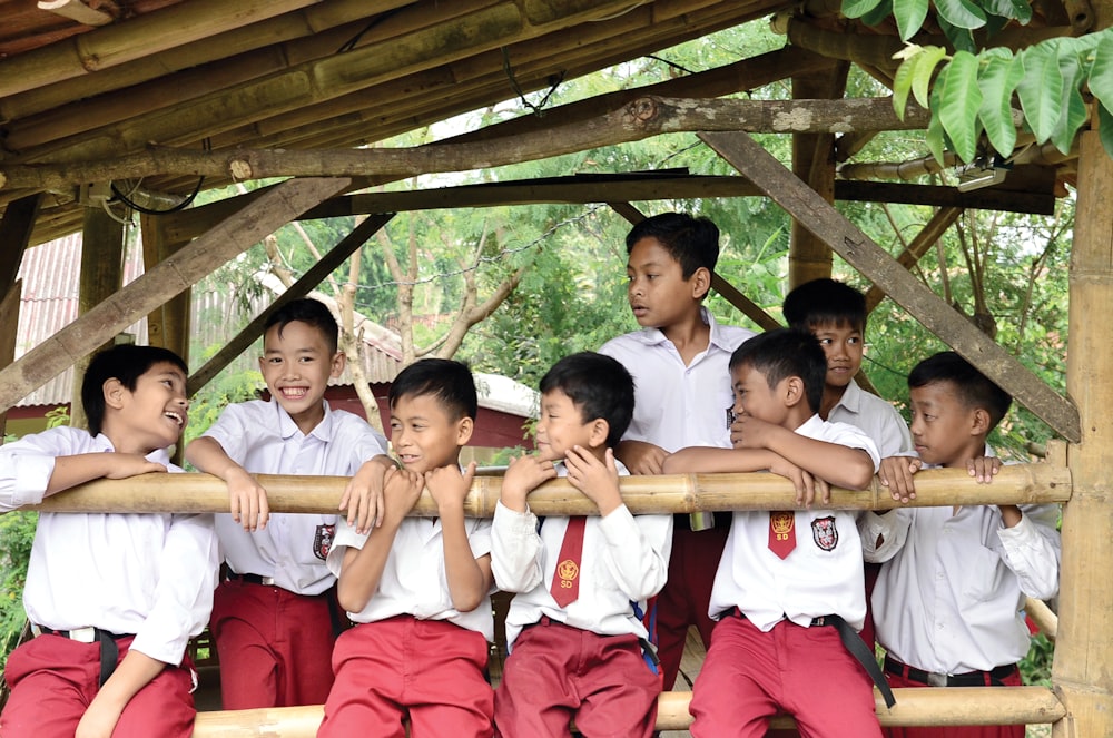 a group of young boys standing next to each other