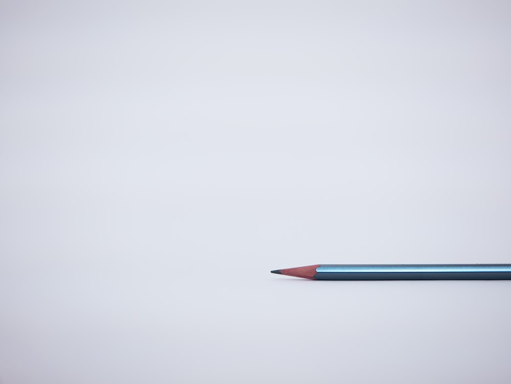 a blue pencil with a red tip sticking out of it