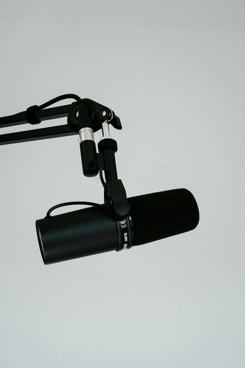 a microphone attached to a tripod on a white background