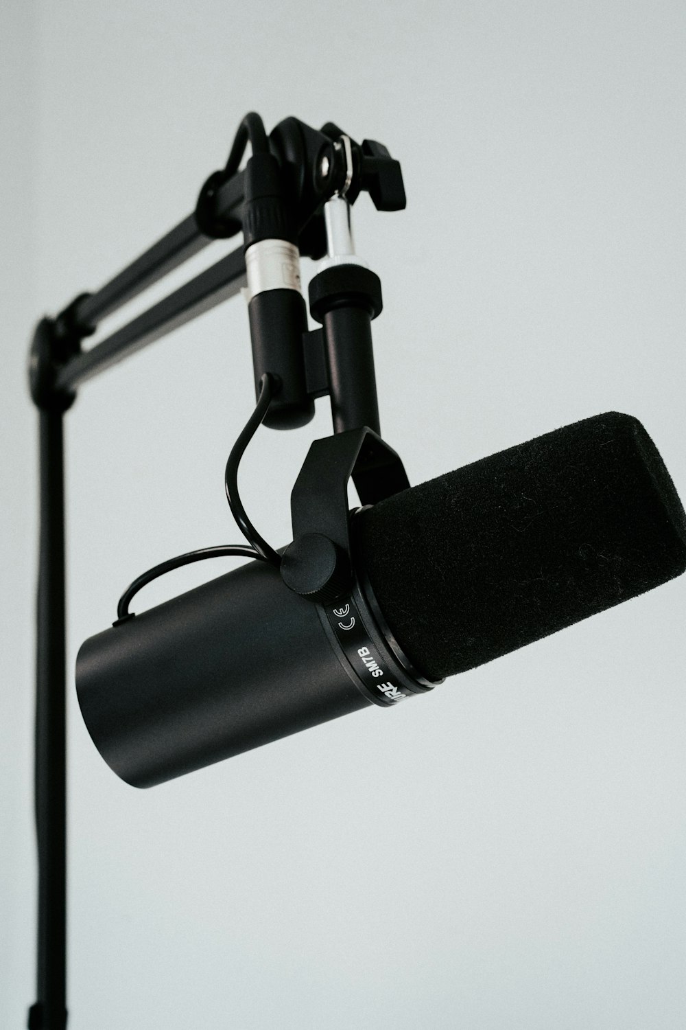 a microphone attached to a tripod on a white background