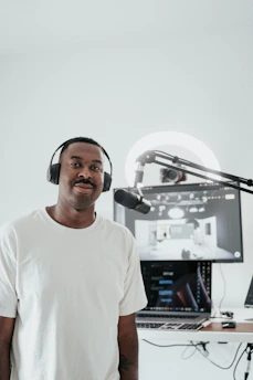 A focused male keto influencer recording content in a minimalist studio setup.