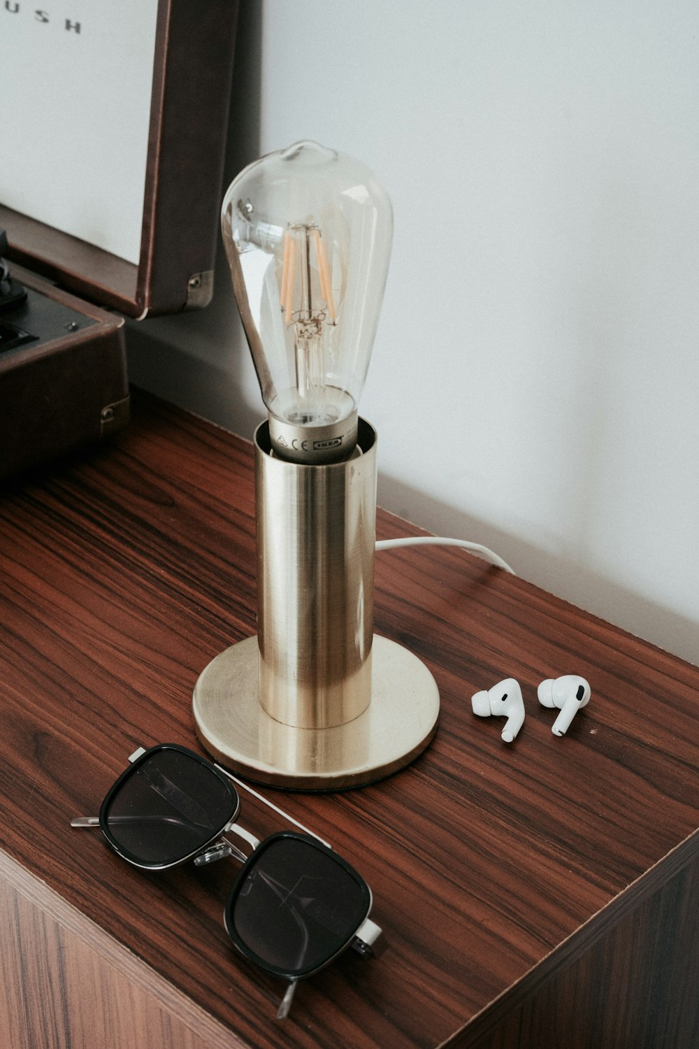 a pair of sunglasses sitting on top of a wooden table