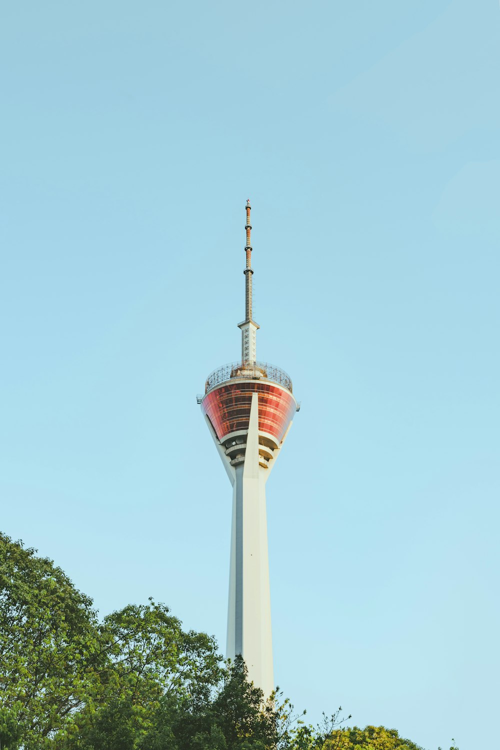 a tall white tower with a red top