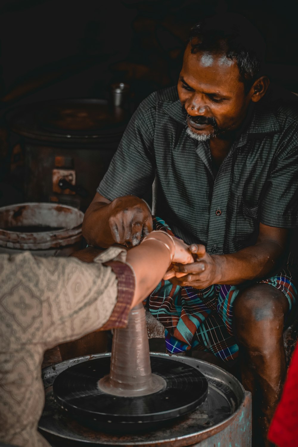 a man is making something with a wheel